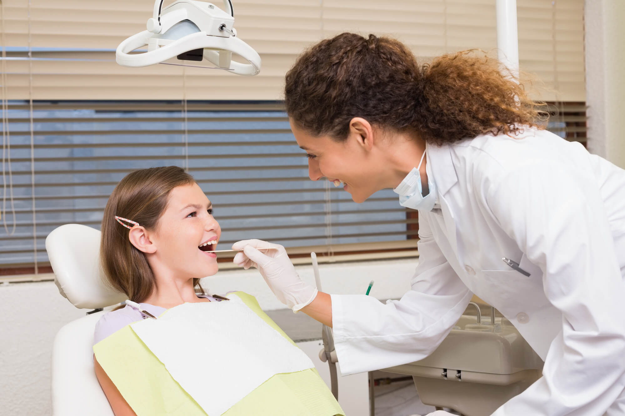 girl patient getting a Pulpotomy Coral Gables 