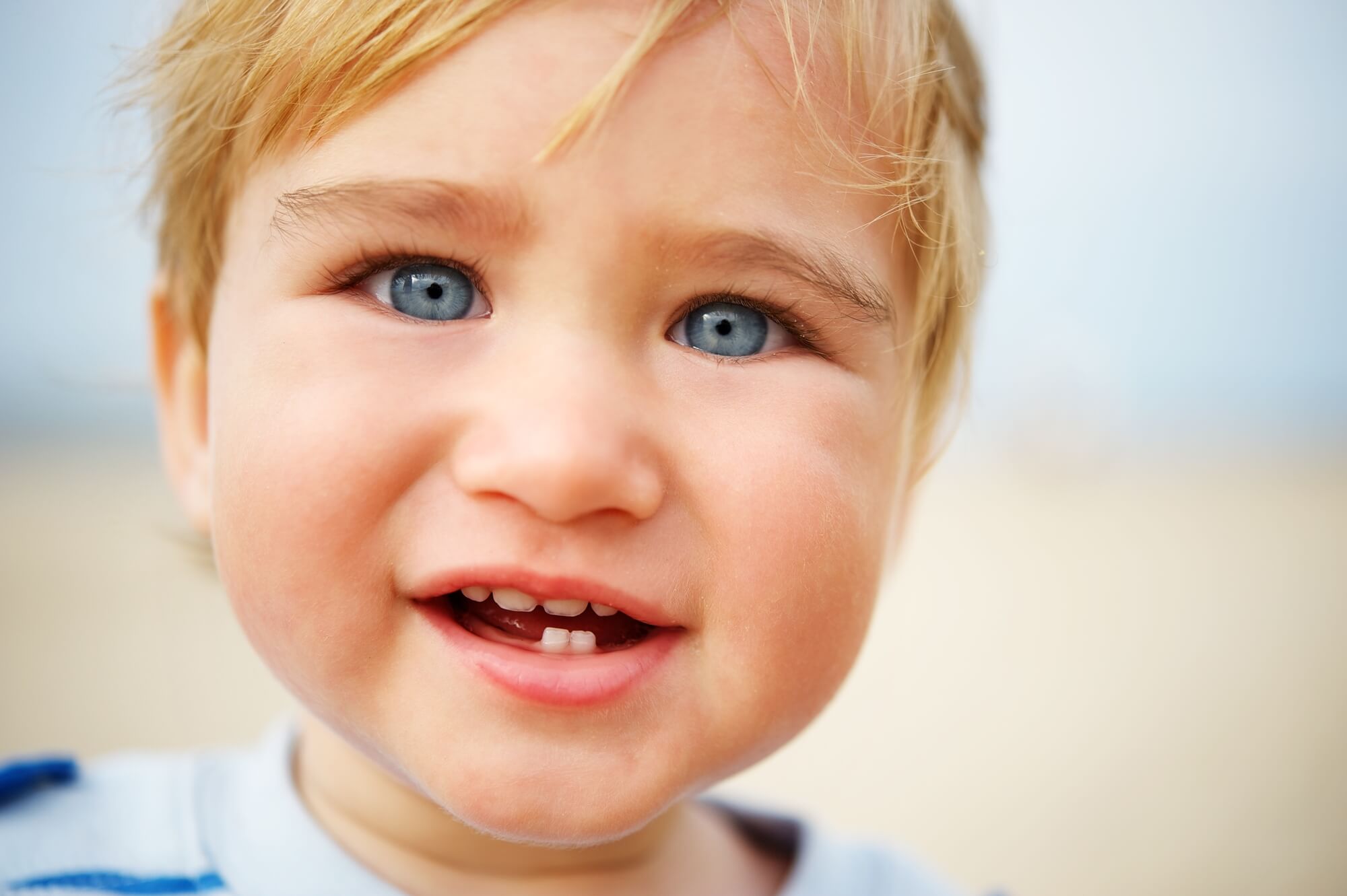 baby with blue eyes about to see a pediatric dentist in Coral Gables